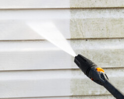 Cleaning service washing building facade with pressure water. Cleaning dirty waill with high pressure water jet. Power washing the wall. Ceaning the facade of the house. Before and after washing